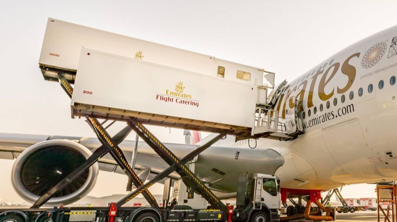An Emirates Flight Catering truck loading an Emirates aircraft
