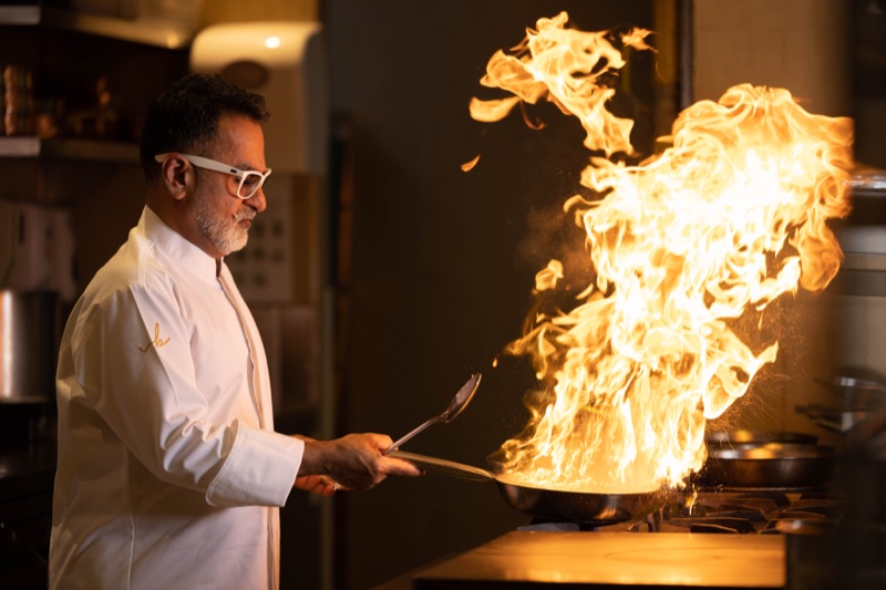 Chef Vineet Bhatia cooking over an open flame
